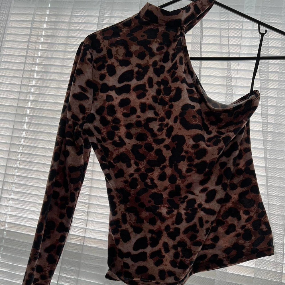One sleeved cheetah print top with exposed shoulder